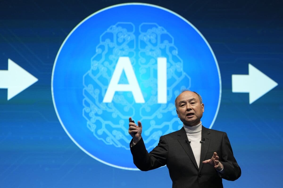 SoftBank CEO Masayoshi Son in suit smiling, with large digital backdrop showing OpenAI logo and AI code, symbolizing…
