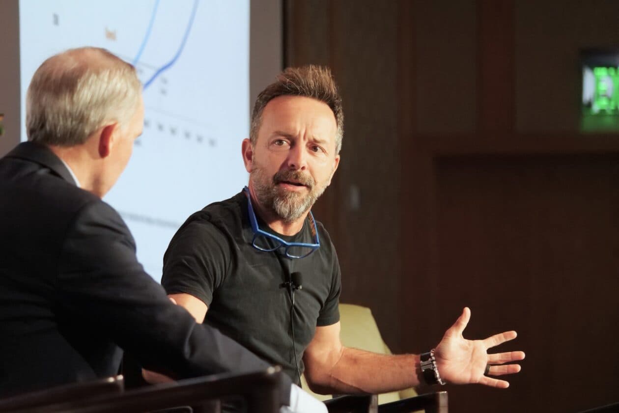 Brad Gerstner of Altimeter Capital speaking on stage, gesturing as he explains the shift to owned AI compute for…