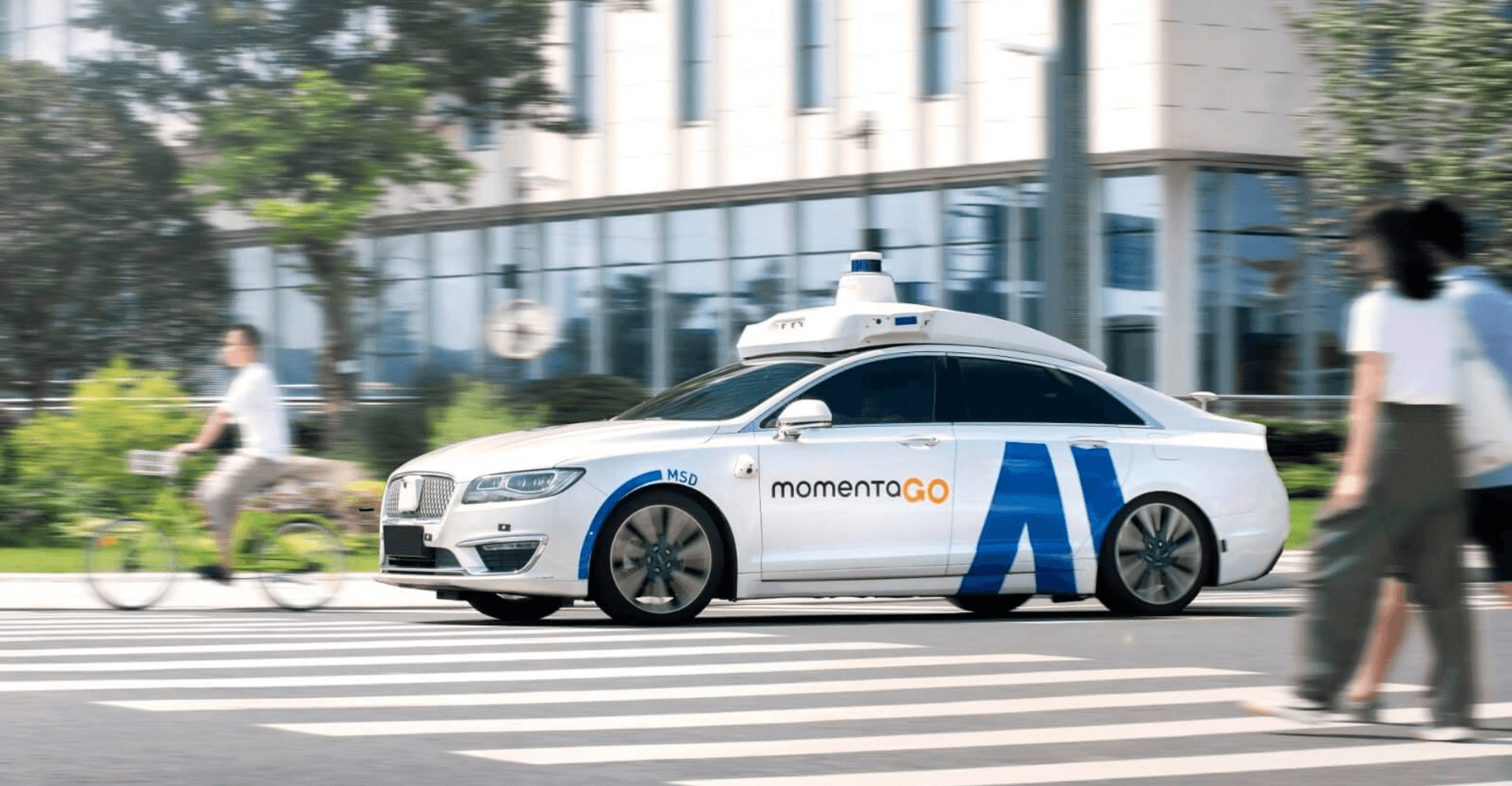 Autonomous driving company Momenta's logo on a dark background with circuit board patterns, symbolizing its tech…