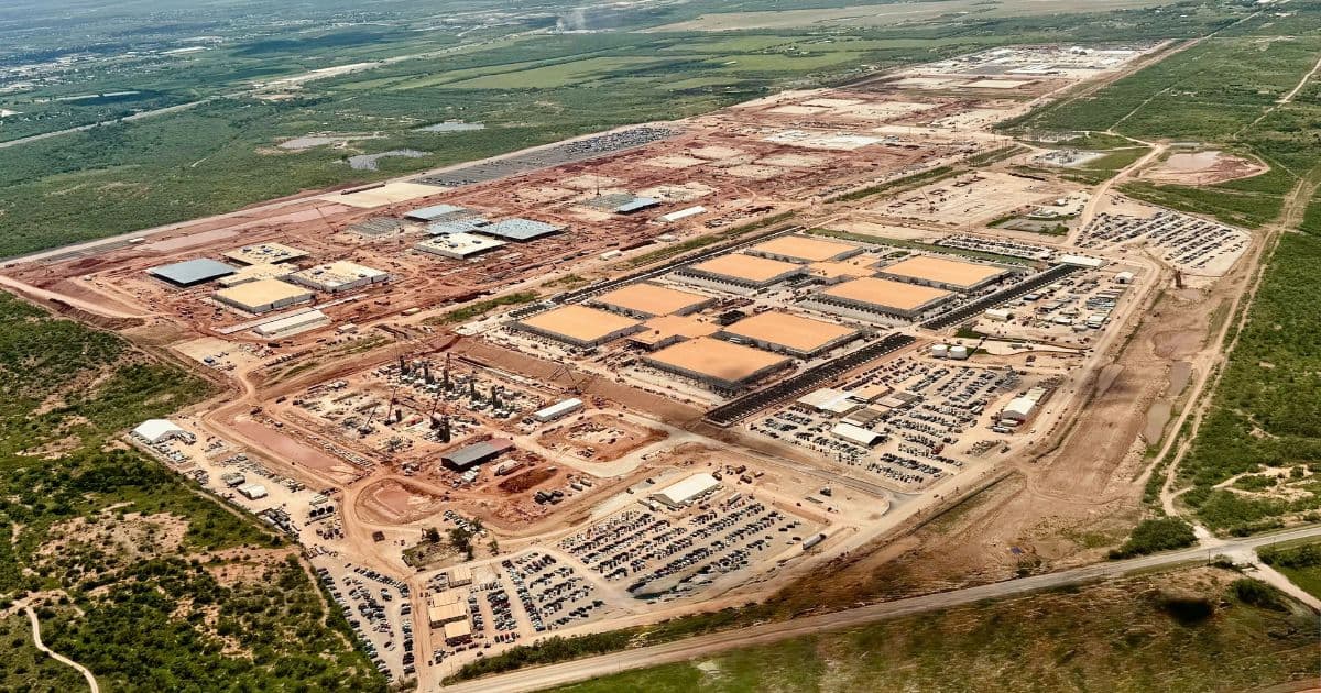 Aerial satellite view showing multiple large rectangular construction sites with earthmoving equipment, concrete…