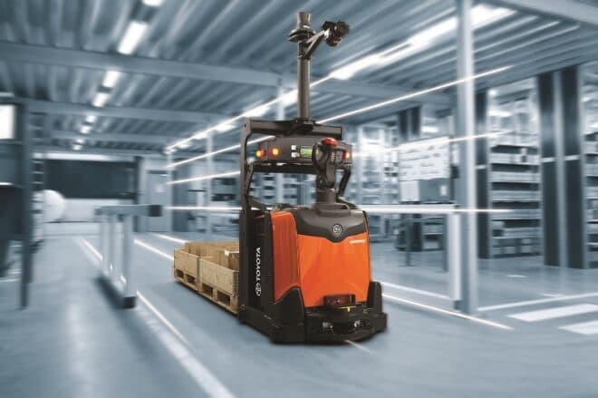 A driverless forklift moves pallets inside a Costco warehouse, autonomously entering a trailer to clear stacked goods