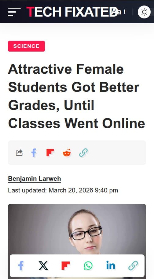 Smiling female student in lecture hall, laptop open, taking notes during class