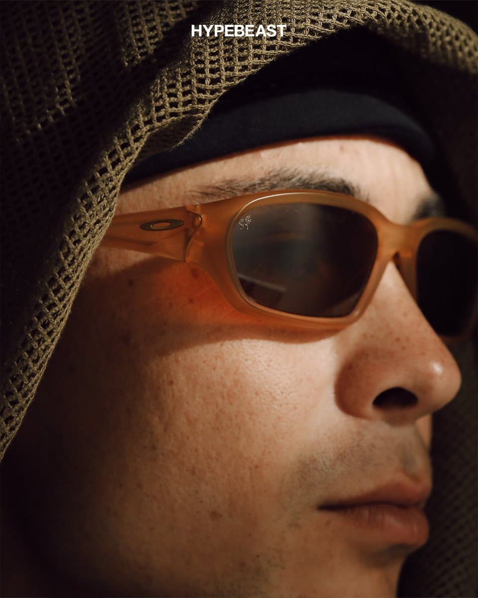 Gold-toned Oakley Terraforma sunglasses displayed inside a custom DSPTCH case against a neutral background