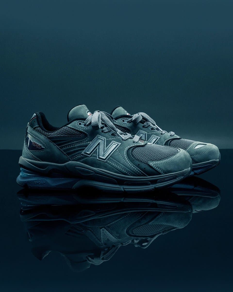White and grey New Balance 2040v5 sneaker with thick sole, displayed on a clean surface, highlighting premium…