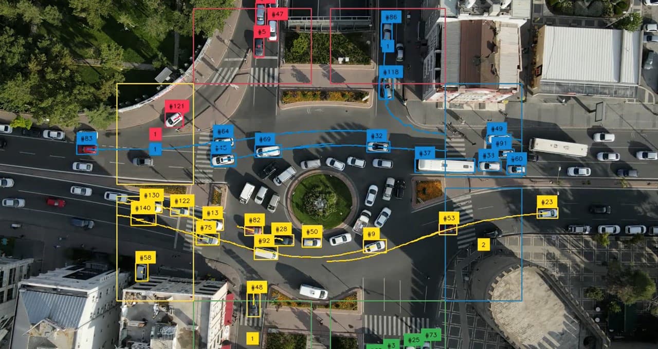 A person using a laptop displaying an AI vision interface with detected objects highlighted by bounding boxes…