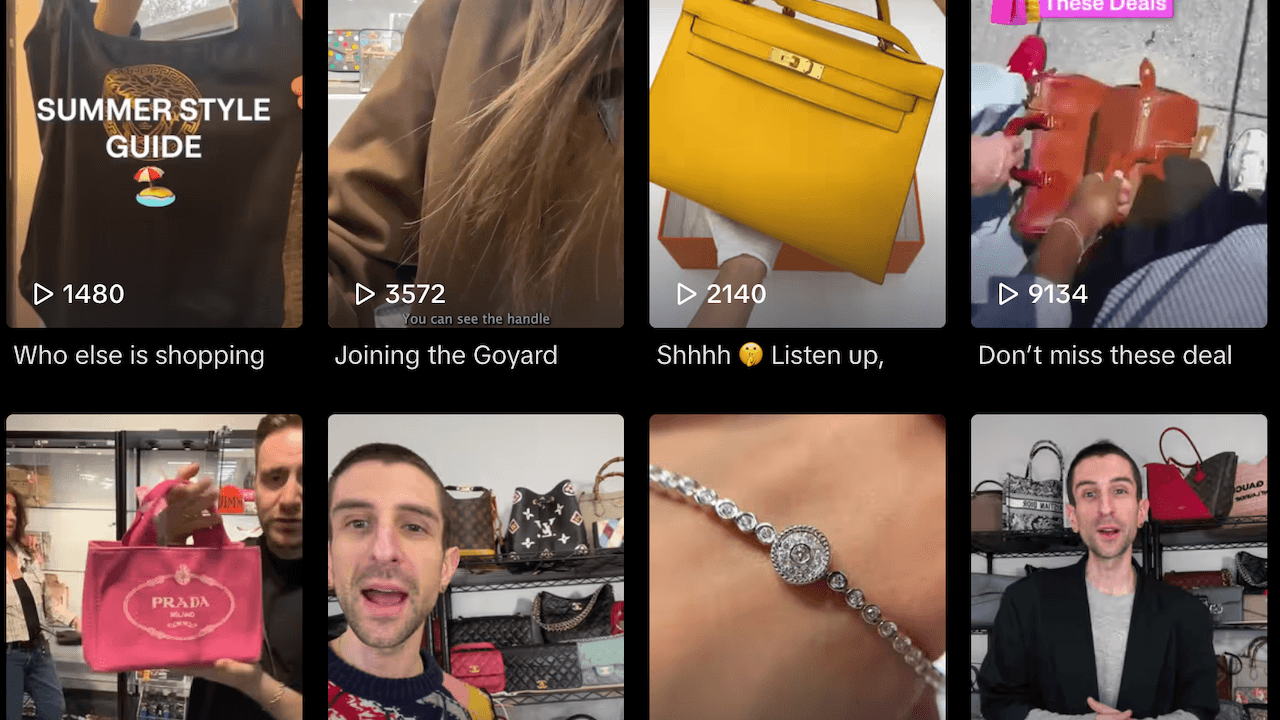 A smartphone held by a shopper captures a luxury boutique interior with designer handbags on shelves, reflecting a…