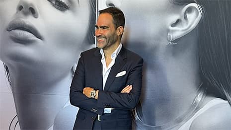 Luca de Meo, Kering CEO, gestures while speaking at a luxury industry conference, with Gucci and Balenciaga brand…