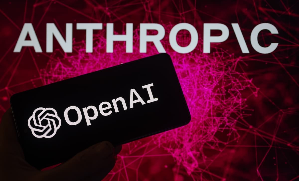 Two smartphone screens display AI chatbot interfaces; one shows Anthropic branding, the other OpenAI, symbolizing…