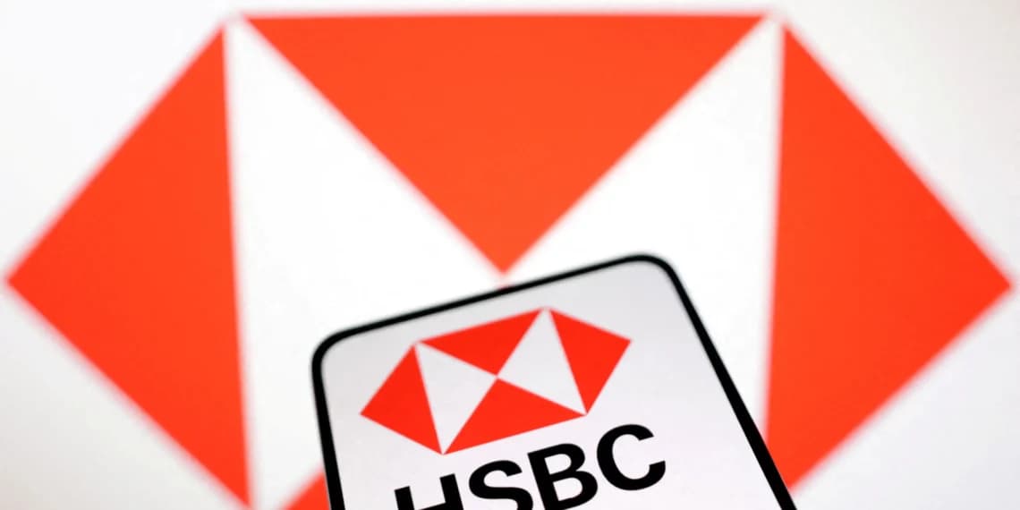 HSBC CFO speaking at a podium with bank logo backdrop, while a bar chart on screen shows declining costs…