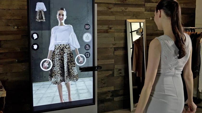 A shopper stands before a smart mirror with an embedded camera, virtually trying on an outfit, reflecting Zalando's…