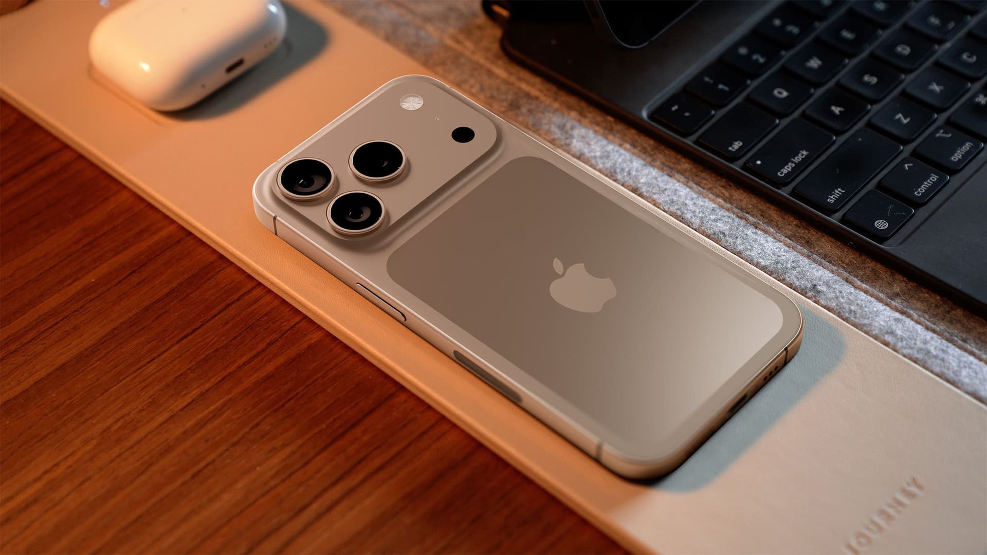 iPhone 17 Pro centered on a desk, displaying a multimodal AI interface, highlighting the sparse, advanced AFM Core…