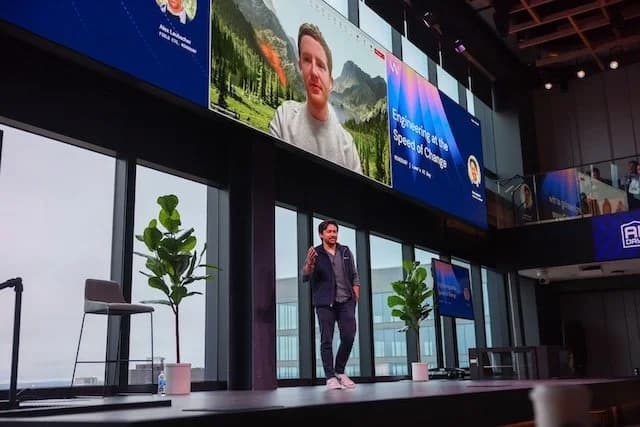 Lowe's employees working alongside multiple digital screens displaying AI agent interfaces in a busy home…