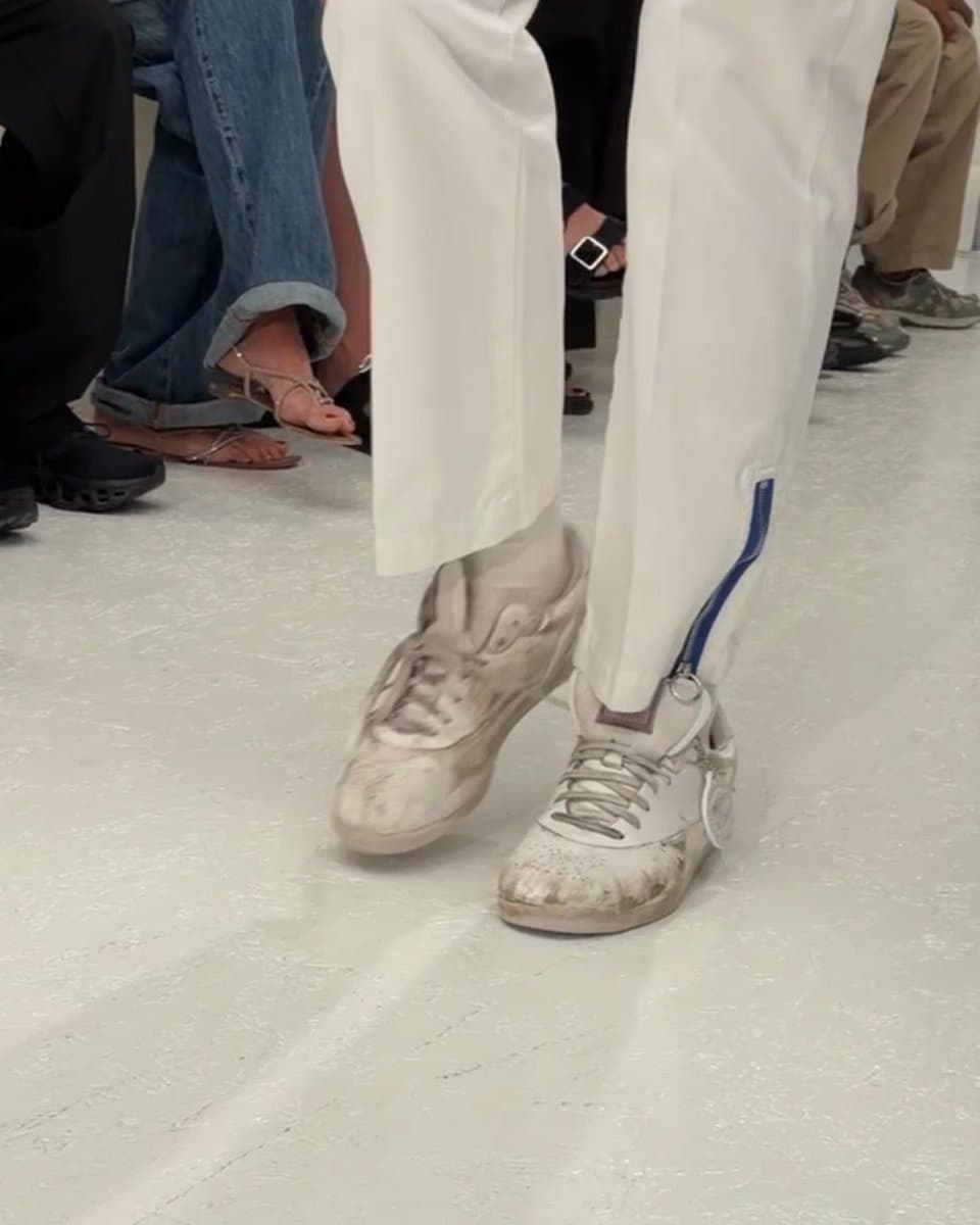 Models walk a runway in CELINE’s SS27 show, wearing the new CELINE x Reebok sneakers with sporty, minimalist design