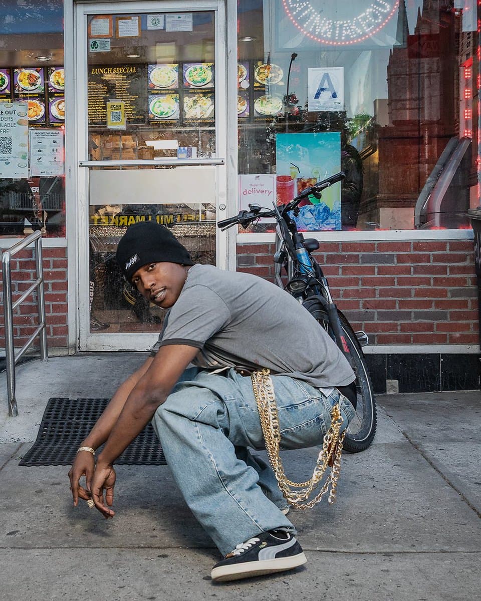 A$AP Rocky wearing a Puma '94 Suede sneaker in a street-style pose, showcasing the classic silhouette with his…