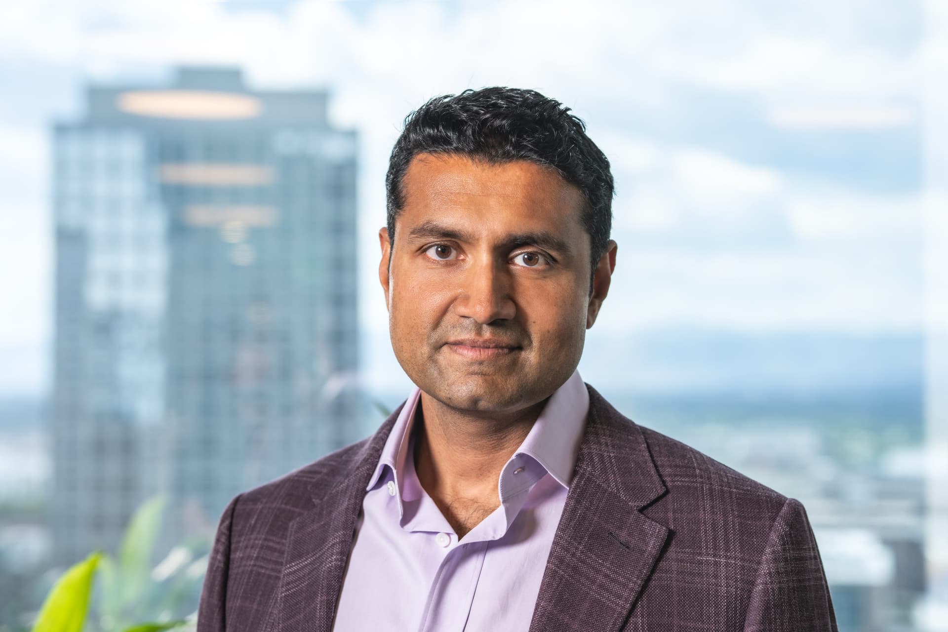 Shyam Sankar, Palantir CTO, speaks at a tech conference, gesturing with one hand while standing at a podium with the…