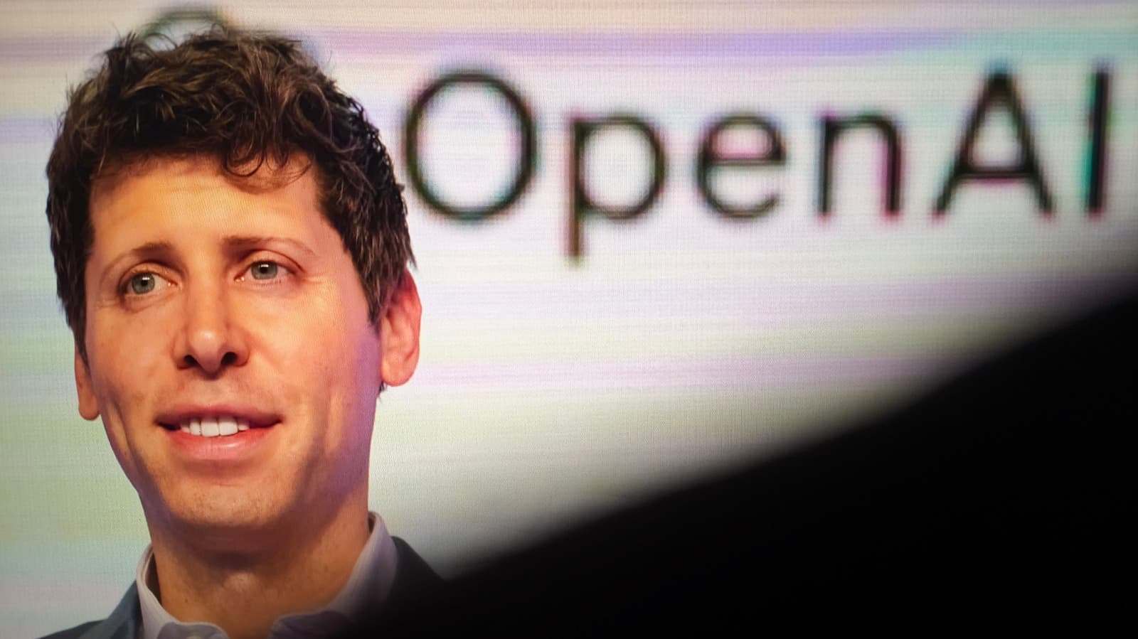 OpenAI executives unveil Daybreak cybersecurity initiative with GPT-5.5 interface on a large screen, Codex Security…