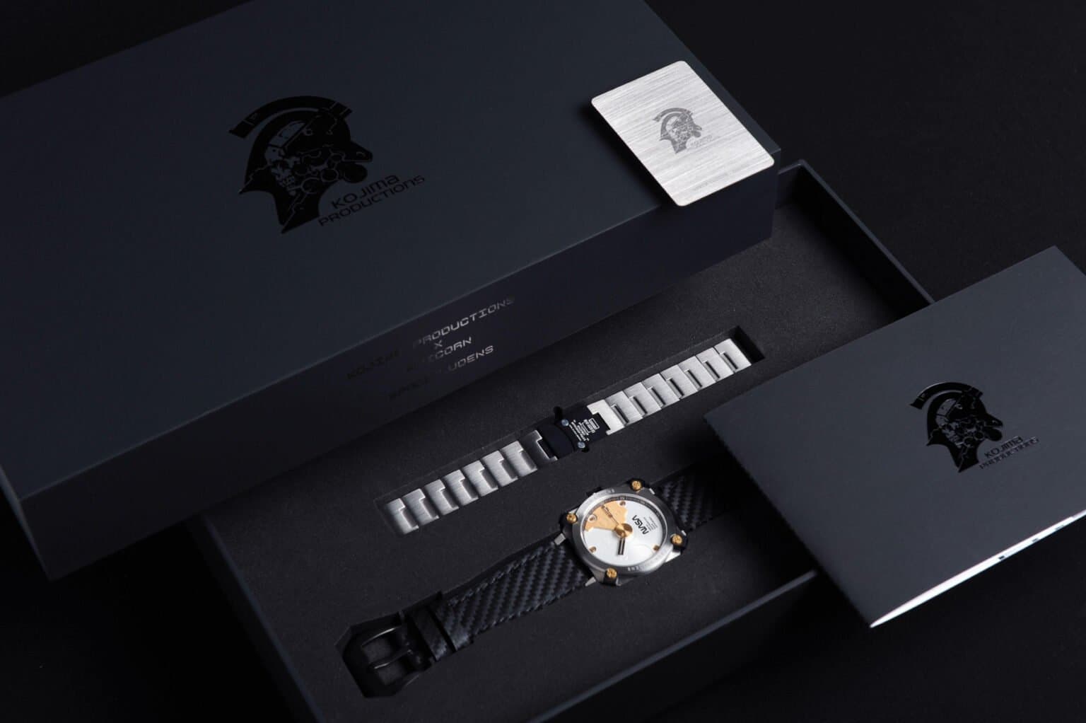 A sleek sci-fi watch with a dark strap and futuristic dial, displayed beside a matching accessory set on a clean…